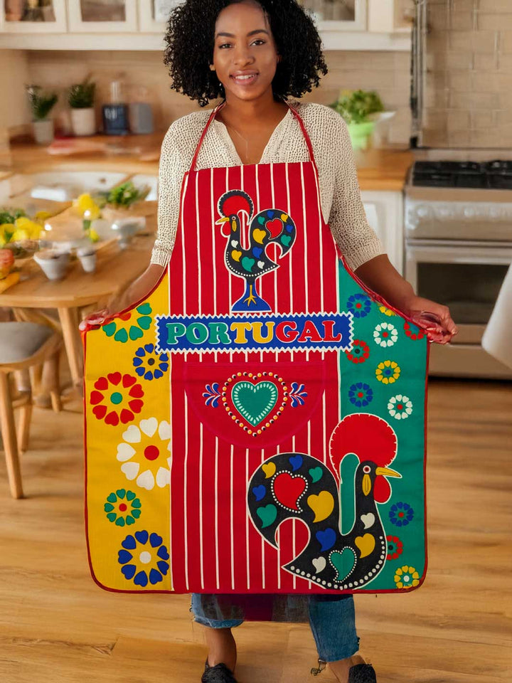 Person wearing a colorful apron with 'Portugal' text in a kitchen.