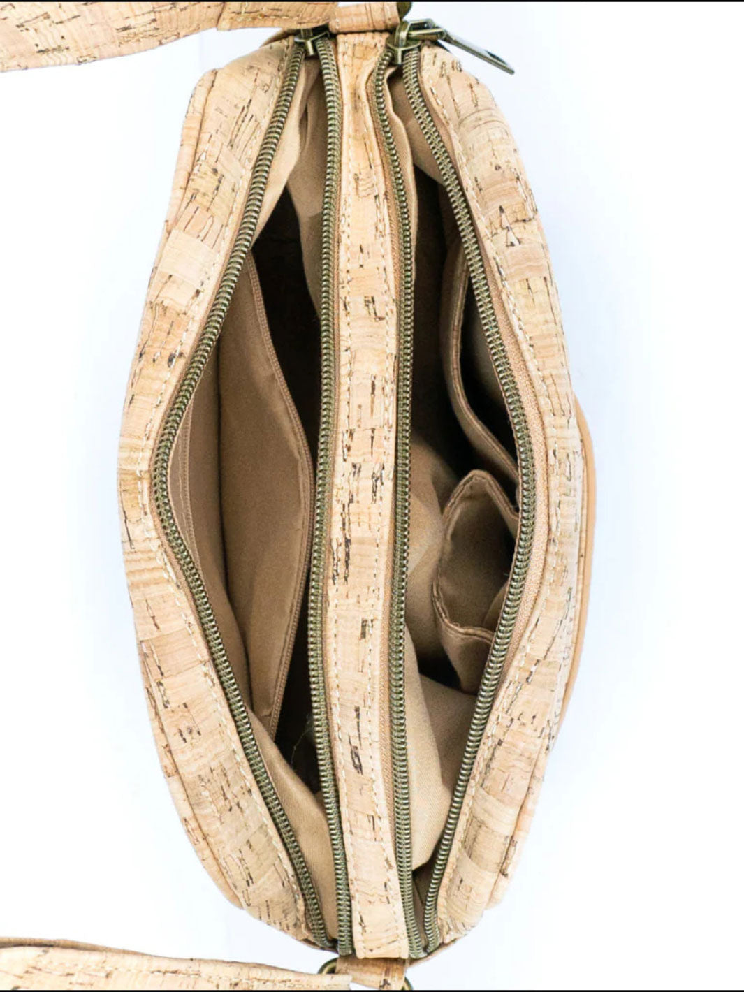 Cork handbag with open zipper showing interior on a white background