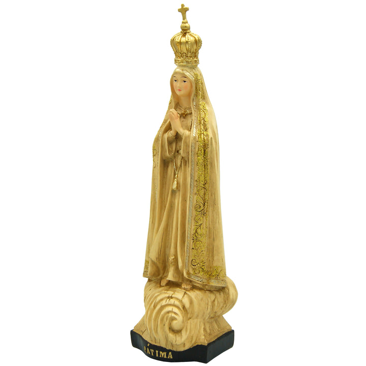 This Our Lady of Fatima statue is made in Fatima, Portugal by the hands of the same artisans that craft the statues of the Shrine of Fatima. The impressive craftsmanship and attention to detail give it a wooden look-alike appearance, although it's made from resin. The figurine sits on a cloud and shows Our Lady wearing a mantle with golden accents painted by hand. On the bottom of the statue it has a music box operated by batteries that plays the Fátima Hymn, Ave.