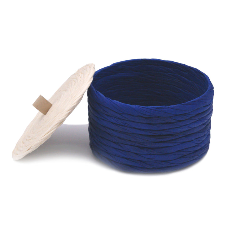 Decorative navy blue box developed through a sustainable process that hardens the fabric, making the pieces durable.