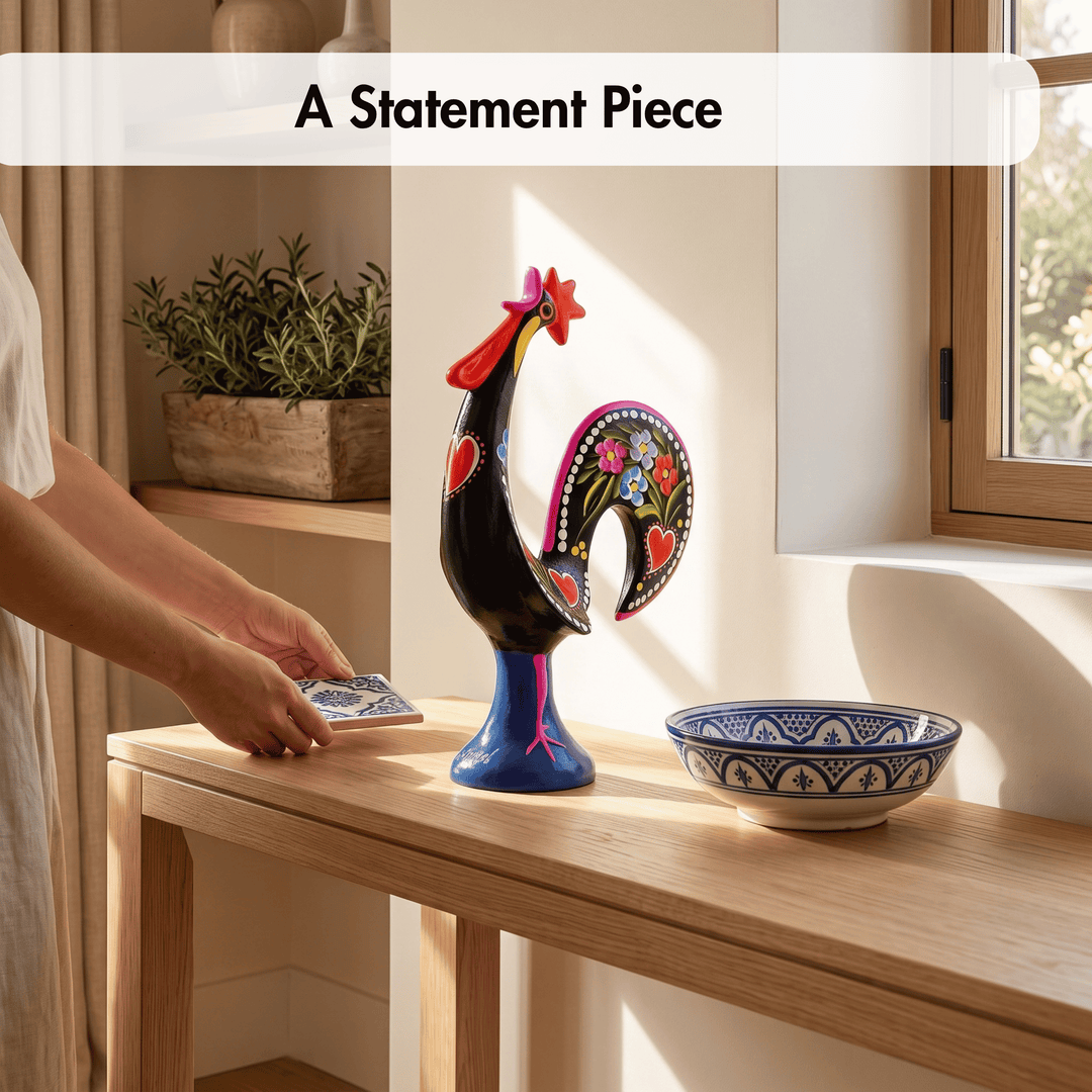 A colorful decorative rooster figurine stands on a wooden table in a sunlit room, next to a blue-and-white patterned bowl. A person&