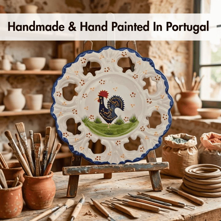 Handmade ceramic plate with rooster design on an easel, surrounded by pottery tools and materials.