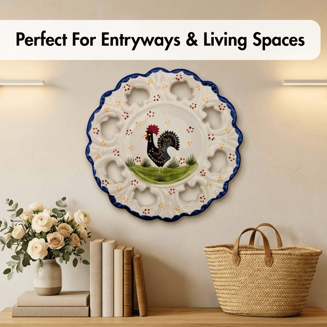 Decorative plate with rooster design on a wall above a shelf with books and a vase.