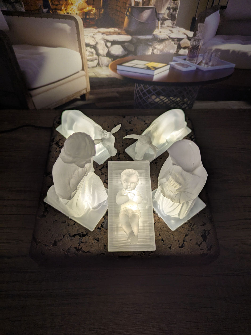 White angel figurines on a dark surface with a blurred background