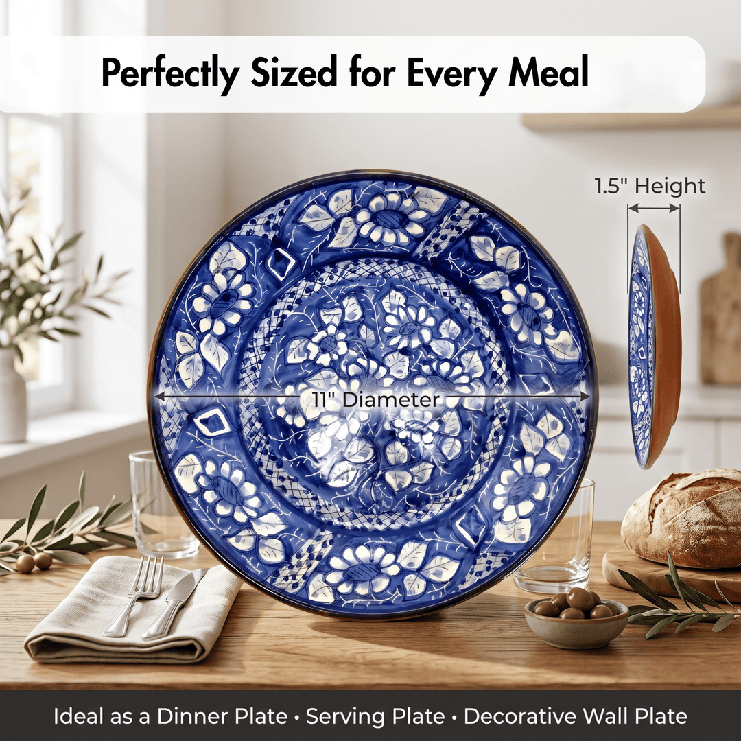 A large round ceramic serving plate with an intricate blue and white floral pattern, shown on a dining table with bread, olives, and glasses. The image includes dimension overlays indicating a 11-inch diameter, 1.
