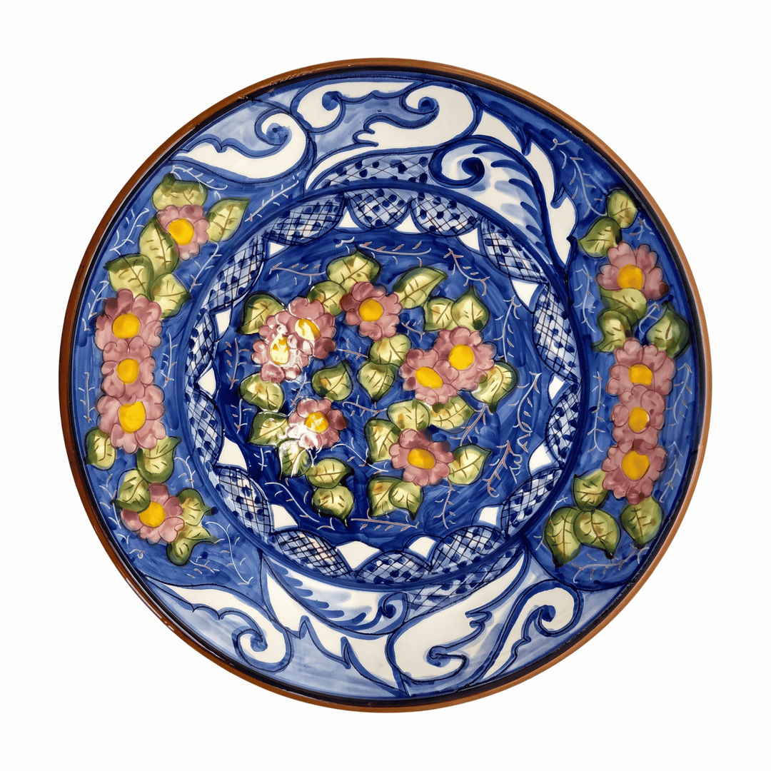 A round ceramic plate with a hand-painted floral pattern in blue, pink, green, and yellow on a white background.