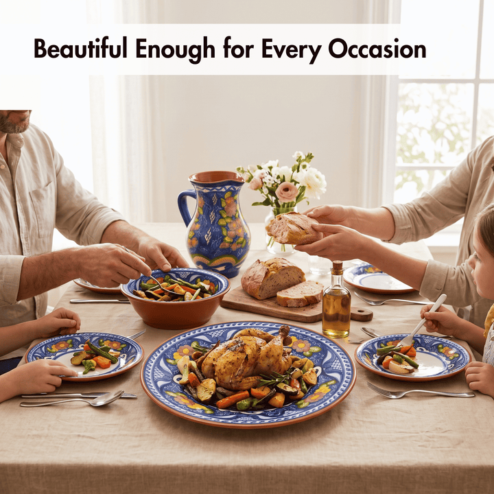 A family dining table set with colorful hand-painted ceramic plates, bowls, and a matching pitcher, with a roasted chicken on the center platter. The scene is warmly lit with a beige tablecloth and a text banner at the top that reads &
