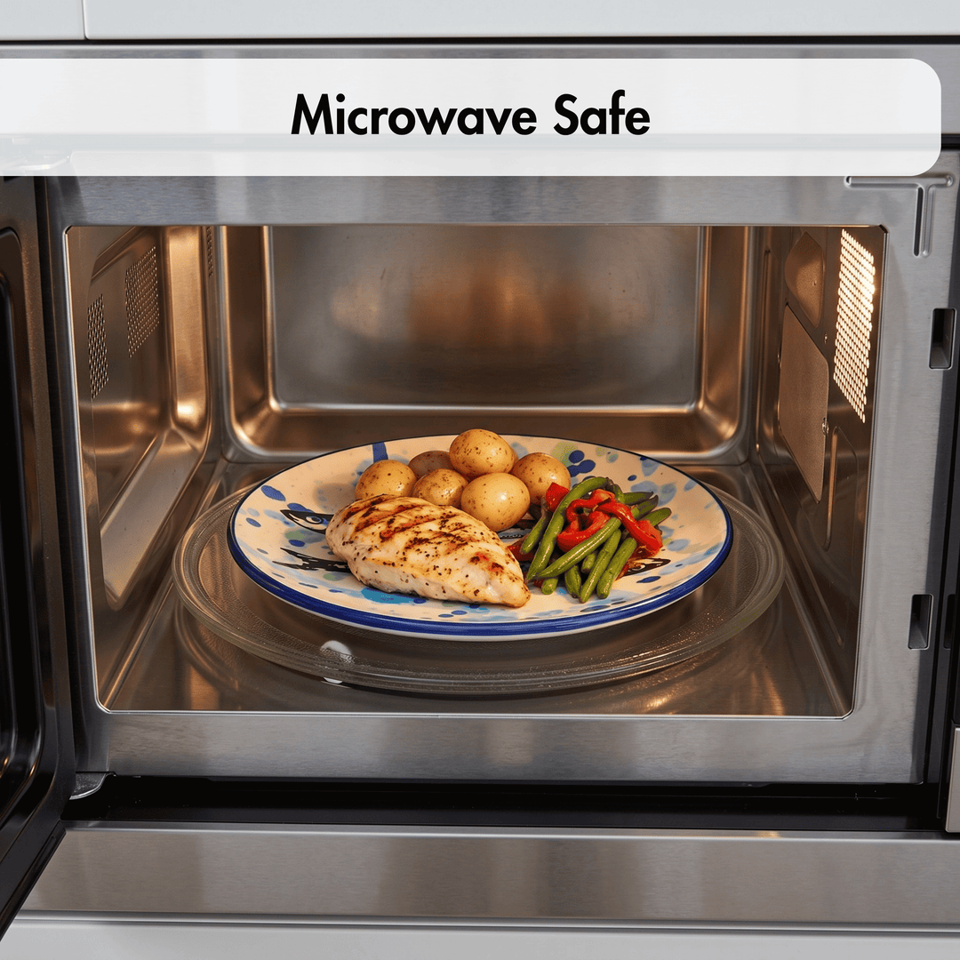 A microwave oven door is open, showing a plate with cooked chicken, potatoes, green beans, and red peppers on the glass turntable inside. A white banner at the top reads &