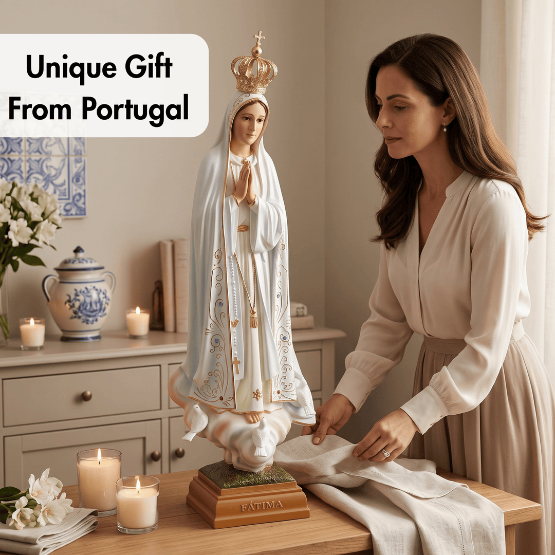 A woman in a beige dress is carefully wrapping a white cloth around a religious statue of the Virgin Mary, set on a wooden table with lit candles and home decor in the background. A text overlay reads &