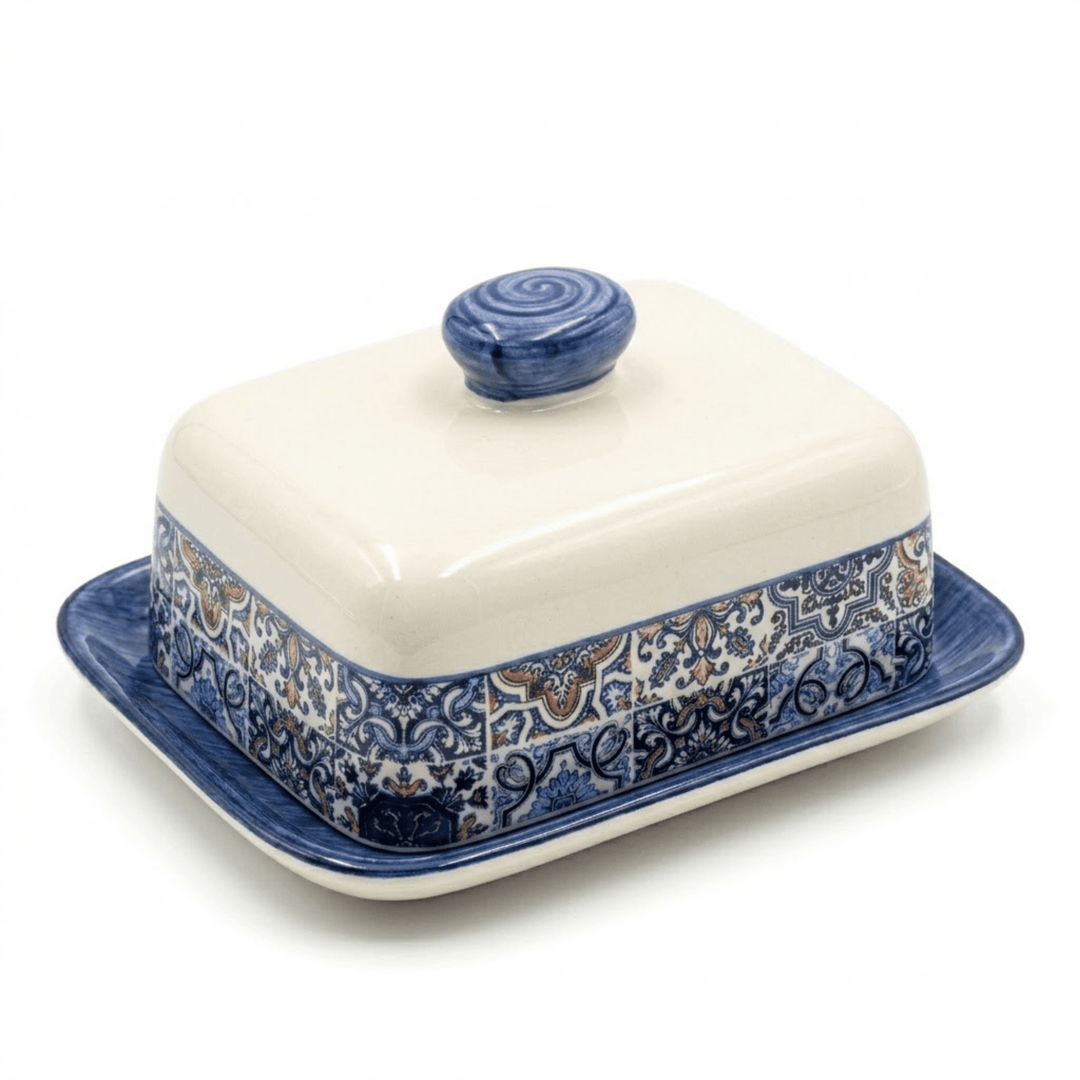 Ceramic butter dish with blue floral patterns on a white background