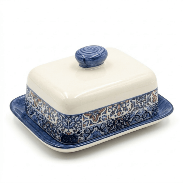 Ceramic butter dish with blue floral patterns on a white background