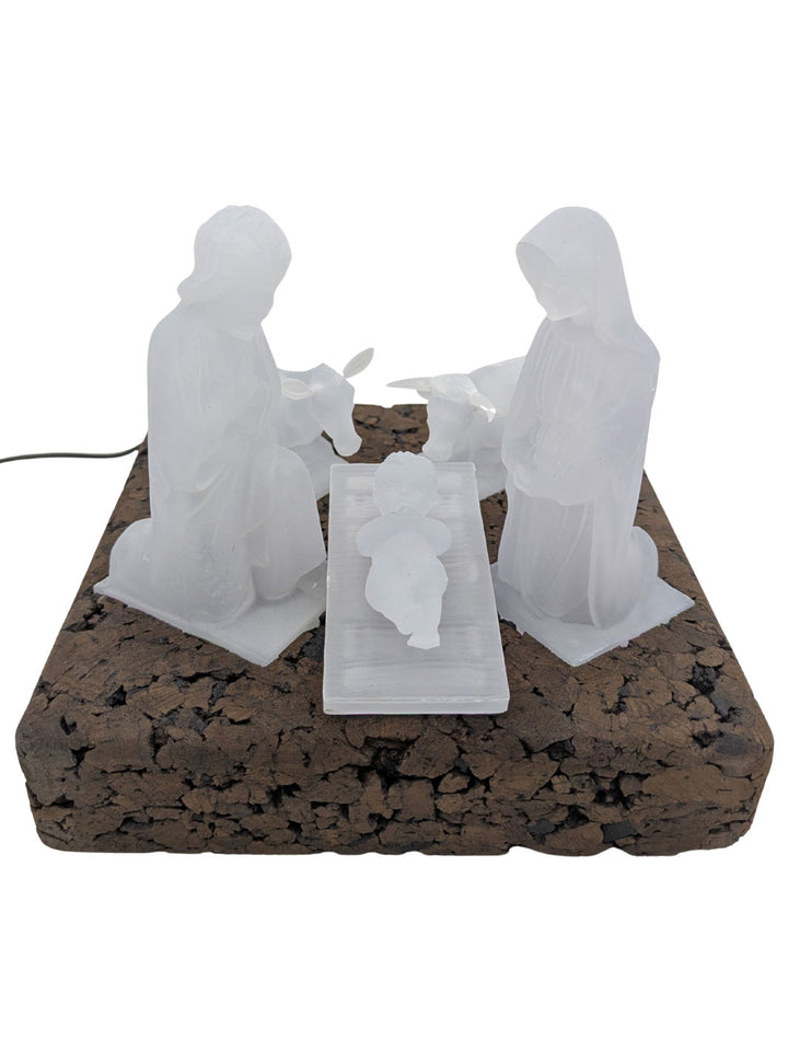 Decorative nativity scene with three figures on a cork base.