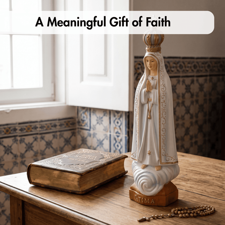 A white and gold Our Lady of Fatima religious statue stands on a wooden table beside an antique book and a wooden rosary, with a white banner at the top reading &