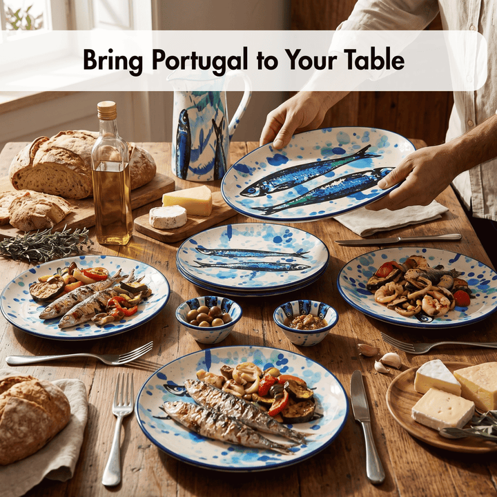 A styled dining table set with multiple ceramic plates and bowls featuring a blue and white fish pattern, shown with food such as grilled fish, bread, cheese, olives, and a pitcher. Two hands are visible holding a plate, and a text banner at the top reads &