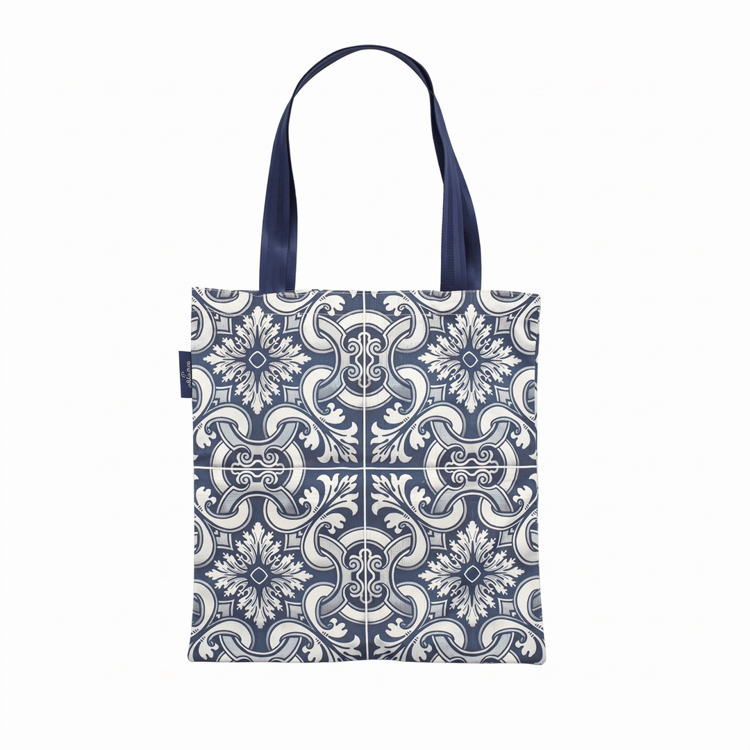 A tote bag with a navy blue and white floral tile pattern, featuring dark navy blue shoulder straps, shown against a plain white background.