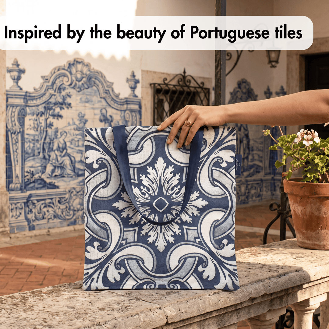 A blue and white patterned tote bag with dark blue handles is held by a person&