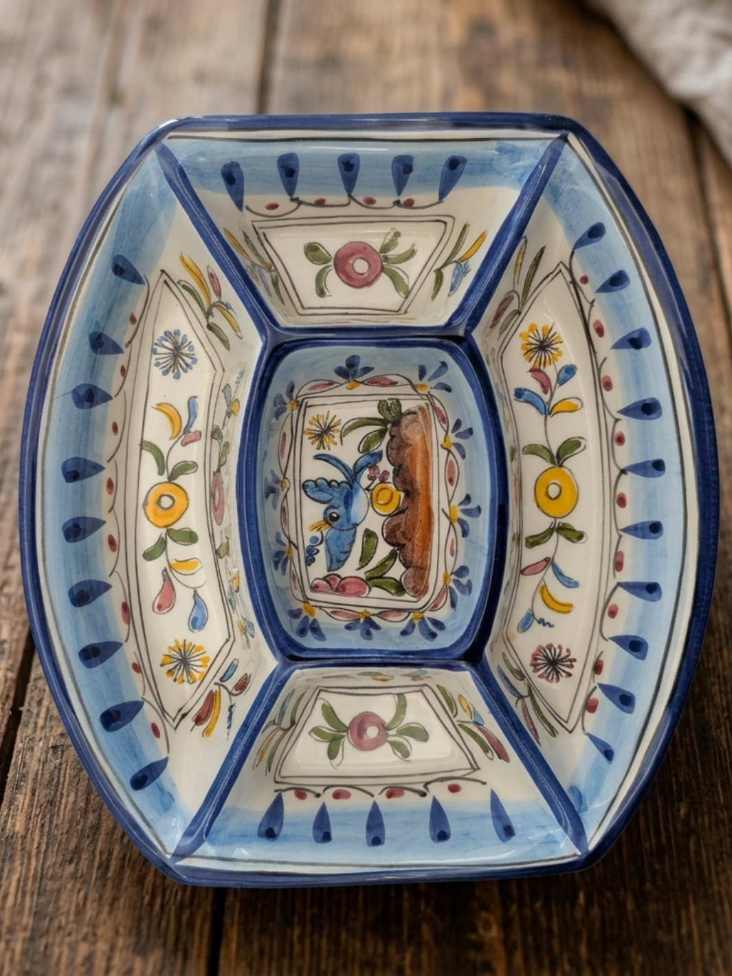 Decorative ceramic bowl with floral patterns on a wooden surface