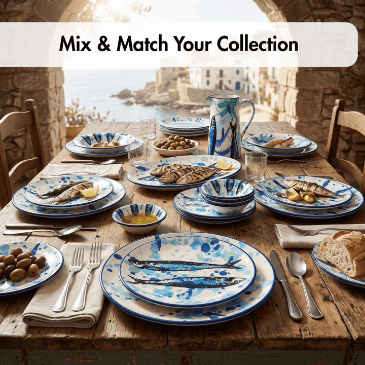 A rustic dining table set with a coordinated blue and white ceramic tableware collection, including plates, bowls, a pitcher, and cutlery, with food and bread in a coastal outdoor setting. A text banner at the top reads &
