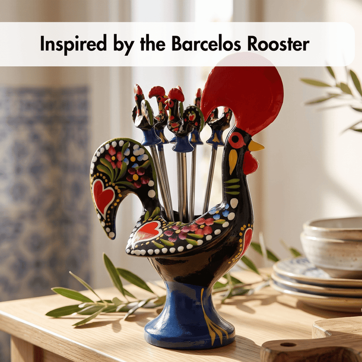 A decorative rooster-shaped utensil holder filled with metal serving tools, displayed on a wooden table with olive branches and stacked plates in a warm indoor setting. Text at the top reads &