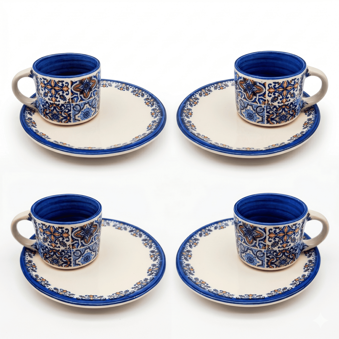 Set of four ceramic cups and saucers with blue and white patterns on a white background