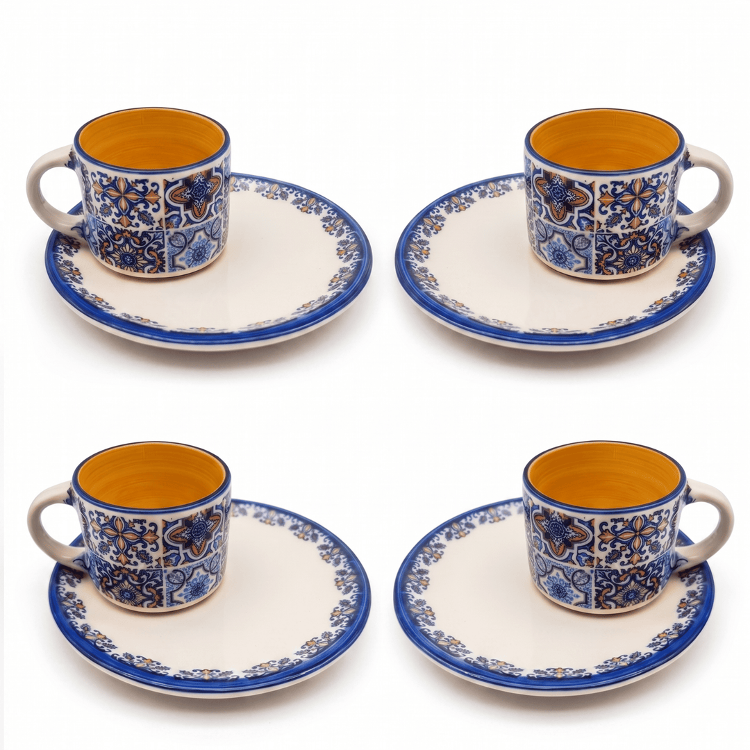 Set of four ceramic cups and saucers with blue and orange patterns on a white background