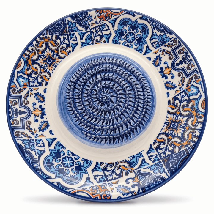 Decorative ceramic plate with blue and white patterns on a white background