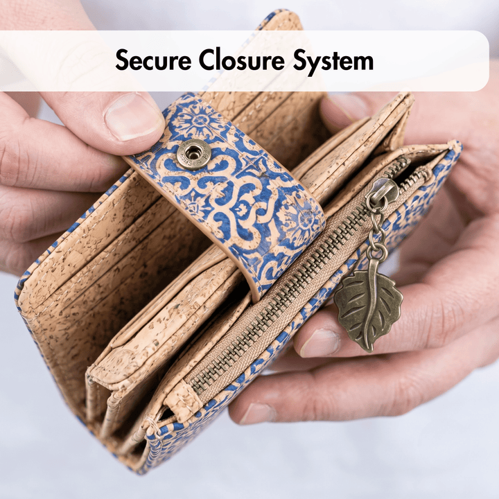 Hand holding a cork wallet with a decorative flap and leaf charm, labeled 'Secure Closure System'.