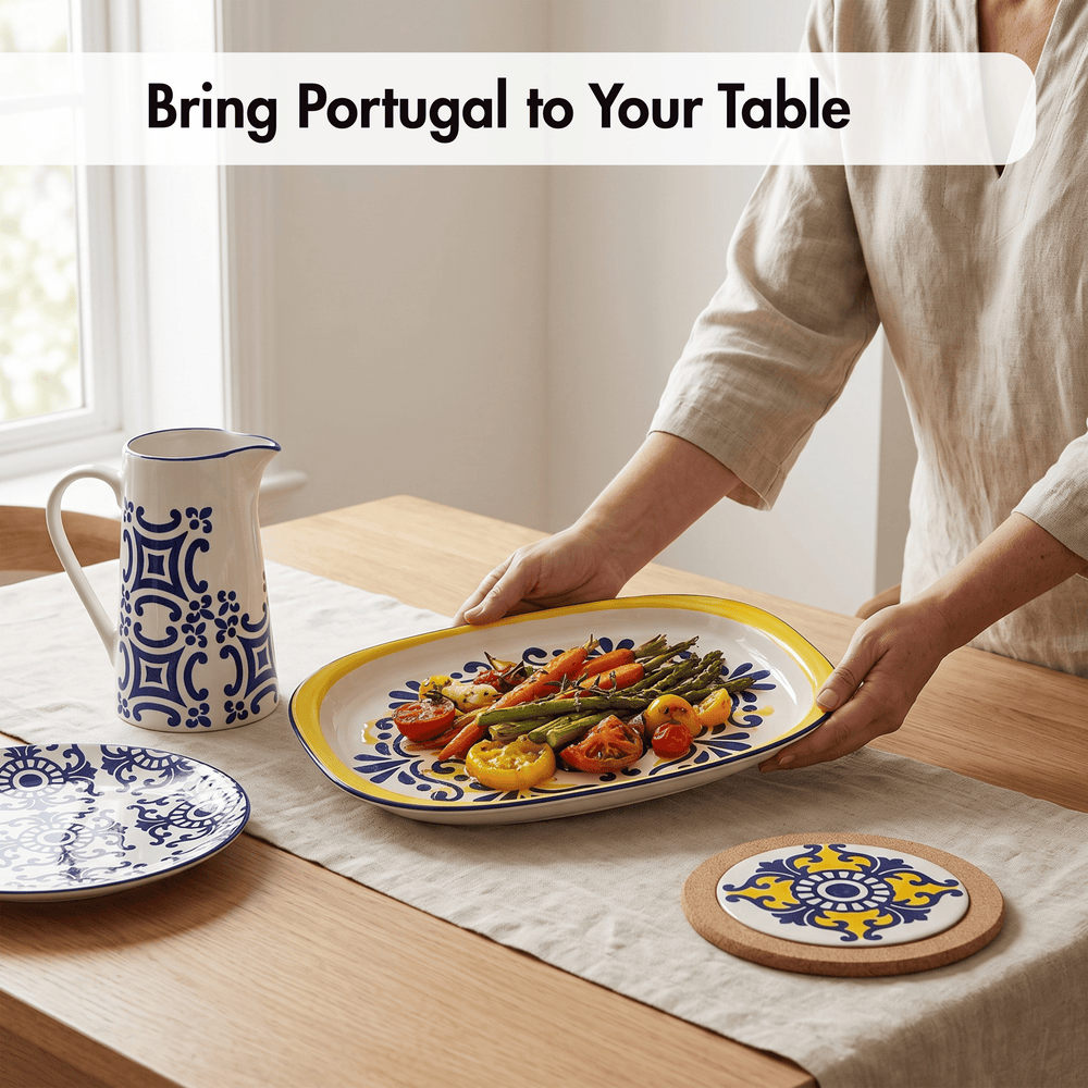 A person in a beige linen top serves food from a large oval Portuguese ceramic platter with blue and yellow patterns on a wooden dining table. A matching blue and white patterned pitcher and a round coaster are also visible on the table, with the text 'Bring Portugal to Your Table' at the top.