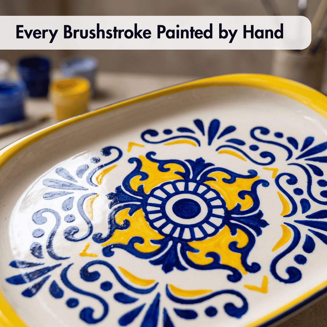 A close-up of a decorative ceramic serving platter with a hand-painted blue and yellow floral pattern on a white background, with a text banner at the top reading &