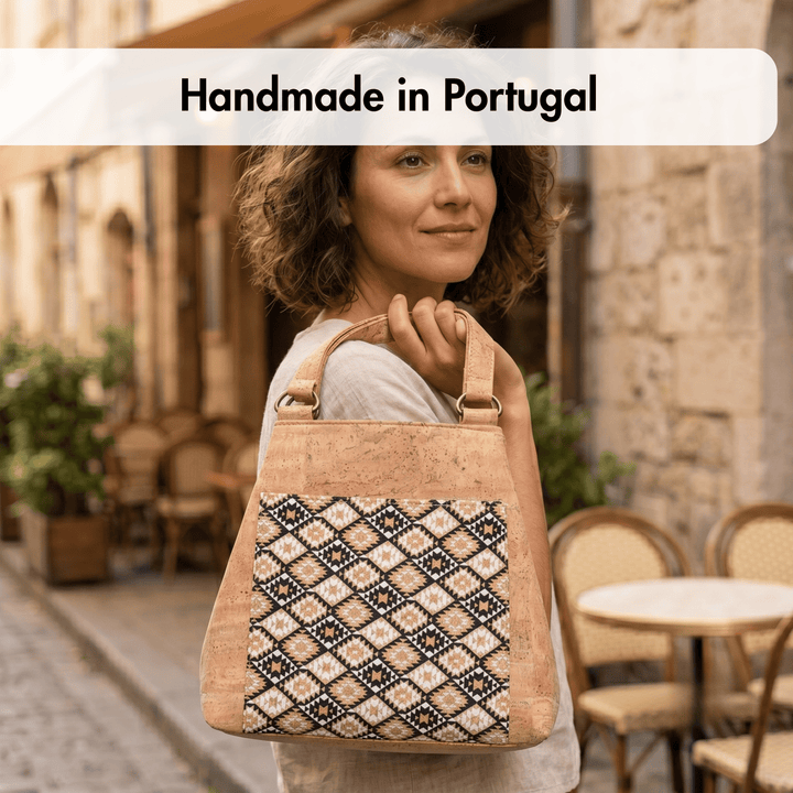 Woman holding a handmade cork bag with 'Handmade in Portugal' text above.