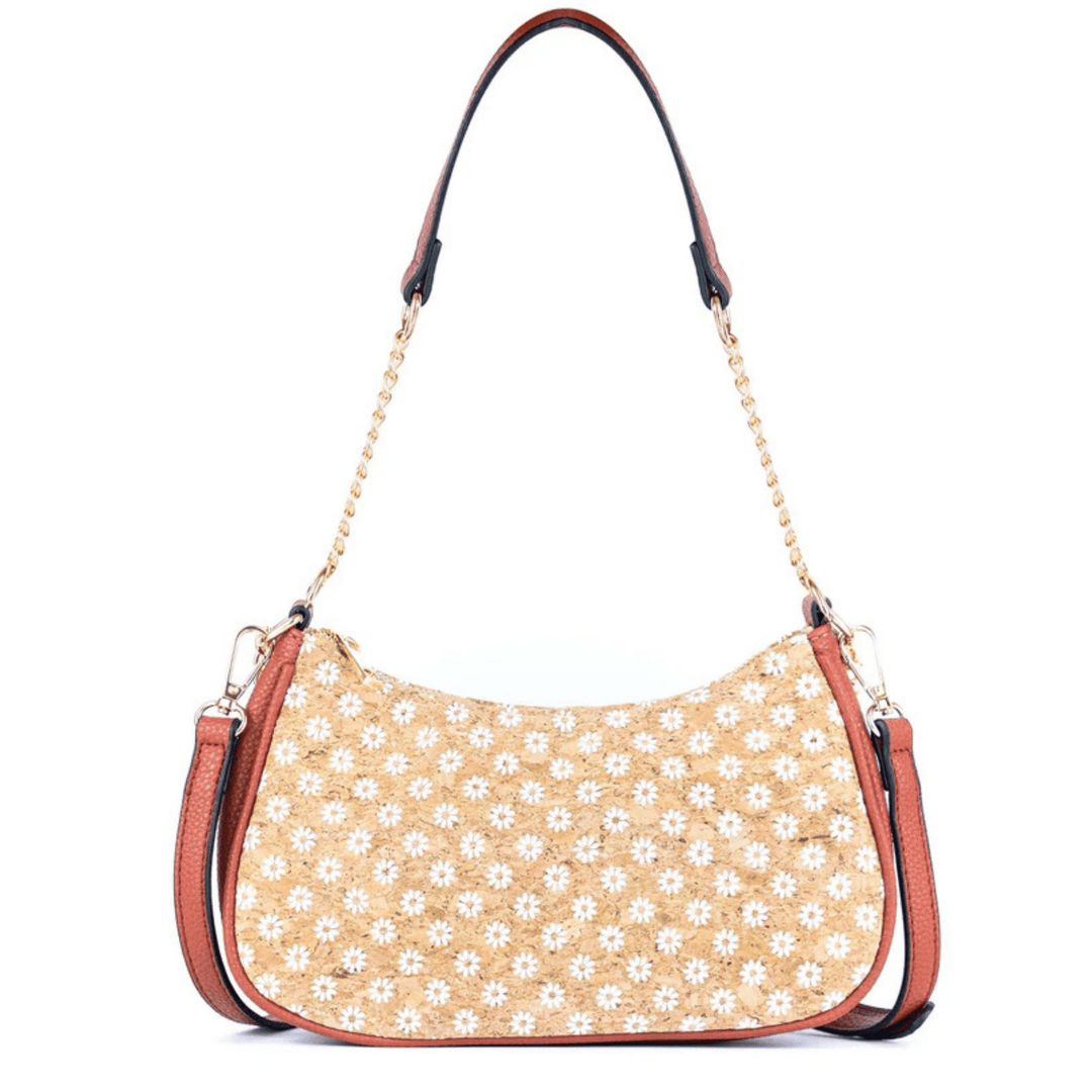 Beige cork handbag with white floral pattern on a white background
