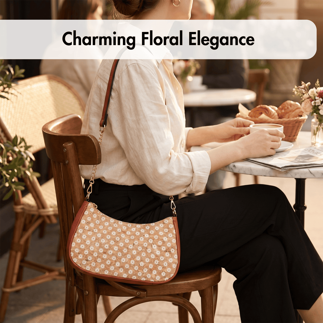 Woman sitting at a cafe table with a floral-patterned cork handbag, holding a cup.