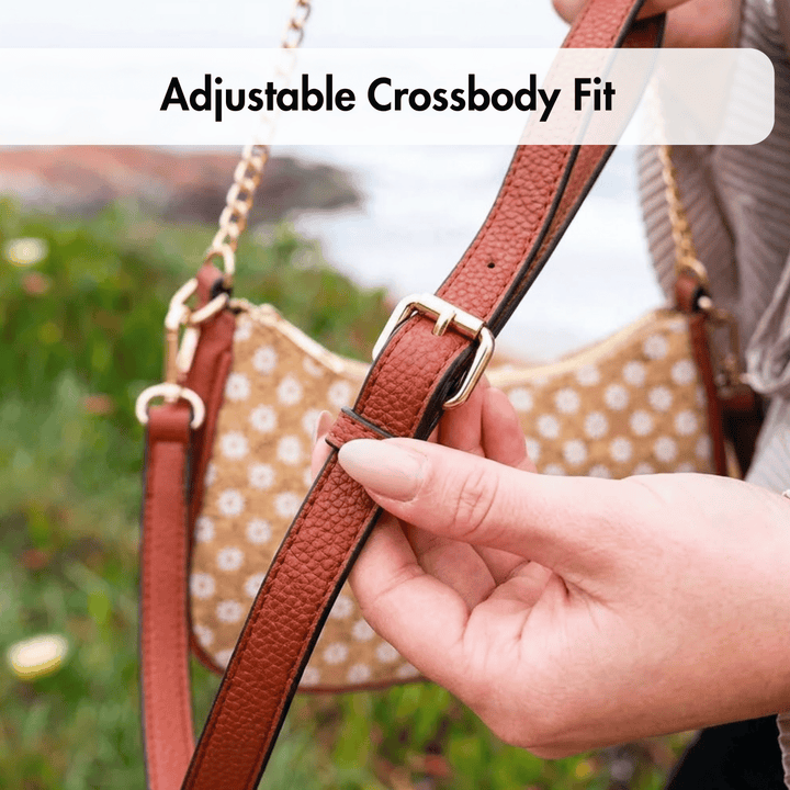 Person adjusting a brown PU leather crossbody strap on a cork bag with text 'Adjustable Crossbody Fit'.