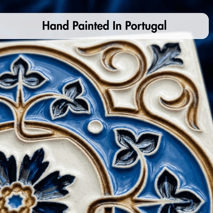 Decorative tile with intricate blue and gold patterns, labeled 'Hand Painted In Portugal'.