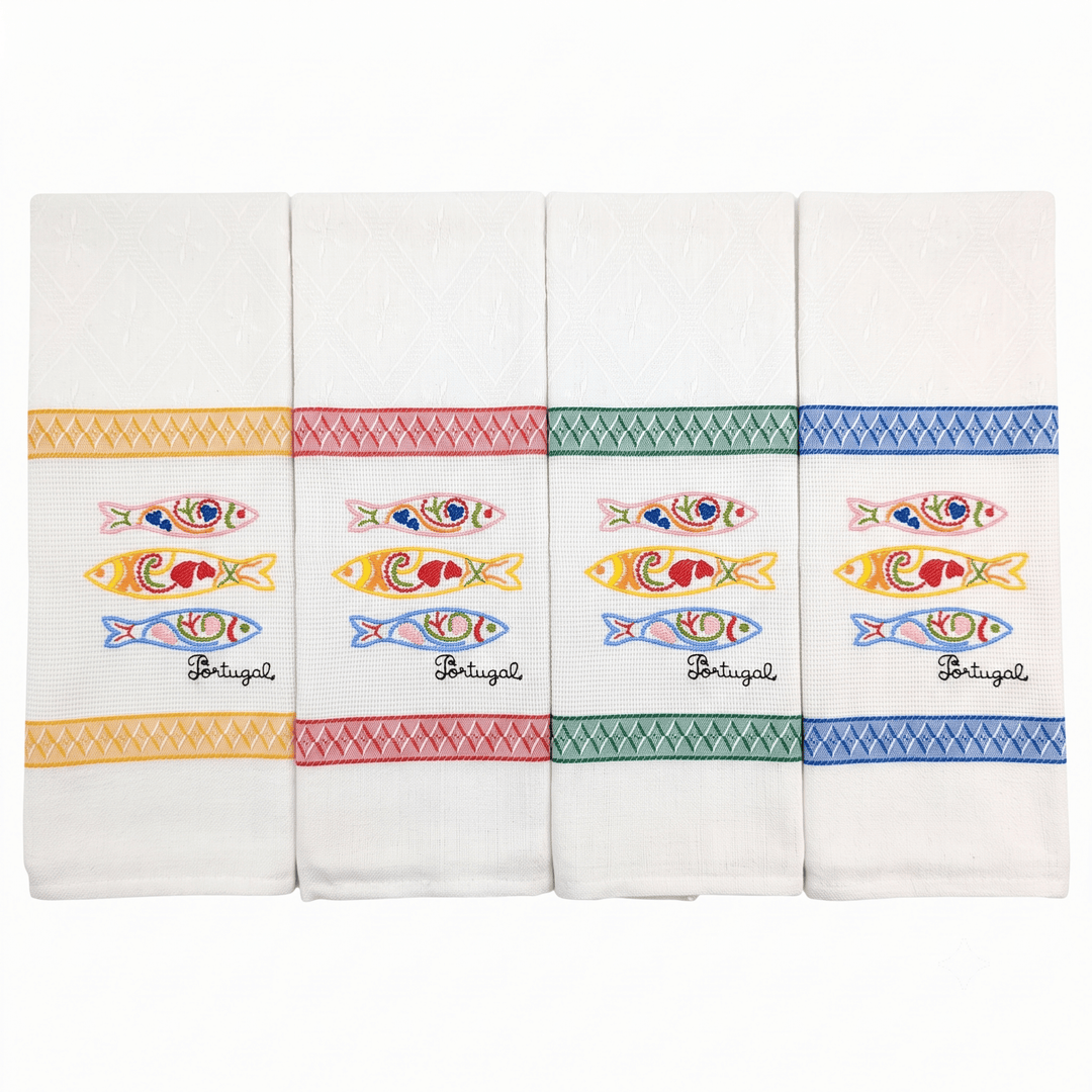 Four white kitchen towels with colorful embroidered sardine motifs and decorative borders, arranged side by side on a white background.