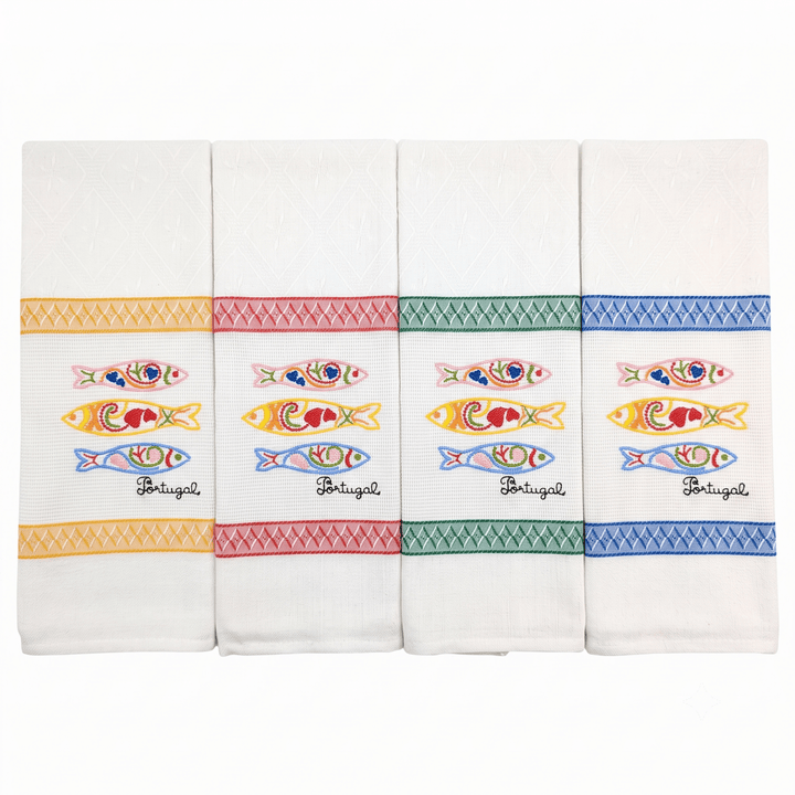 Four white kitchen towels with colorful embroidered sardine motifs and decorative borders, arranged side by side on a white background.