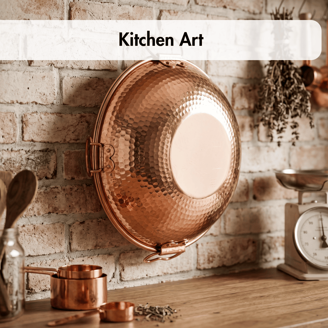 A hammered copper-colored metal pan or pot cover hanging on a brick wall above a wooden countertop with kitchen utensils and a scale. A white banner at the top reads &