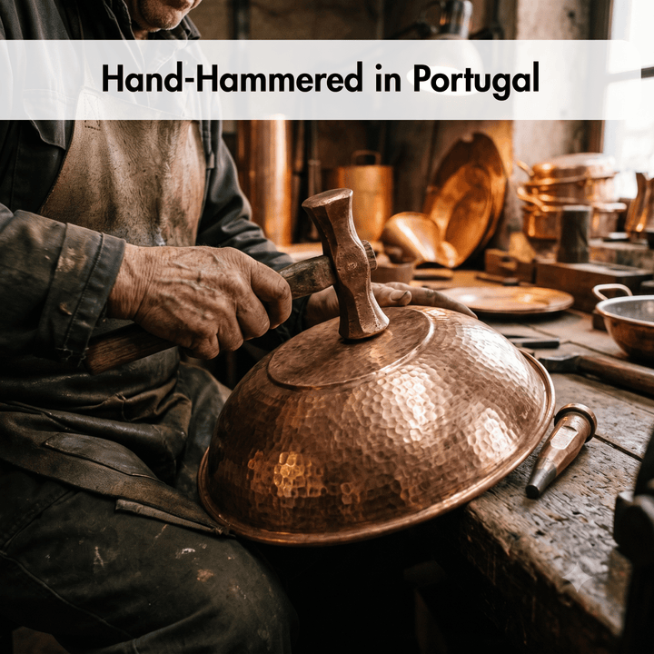 A hammered copper pot lid being shaped by a craftsman with a hand-hammer in a rustic workshop, with text overlay reading &