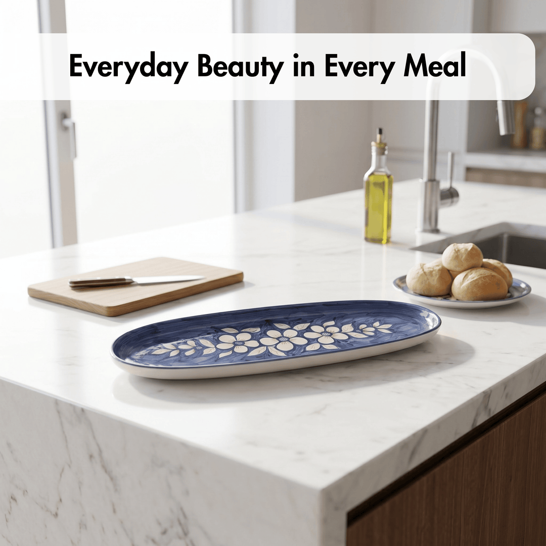 Blue floral-patterned tray on a kitchen counter with bread and olive oil.