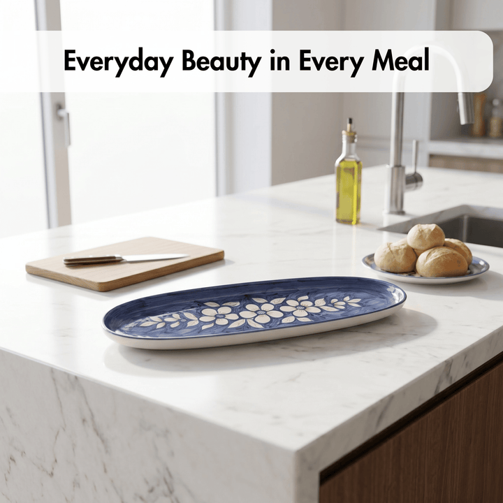 Blue floral-patterned tray on a kitchen counter with bread and olive oil.