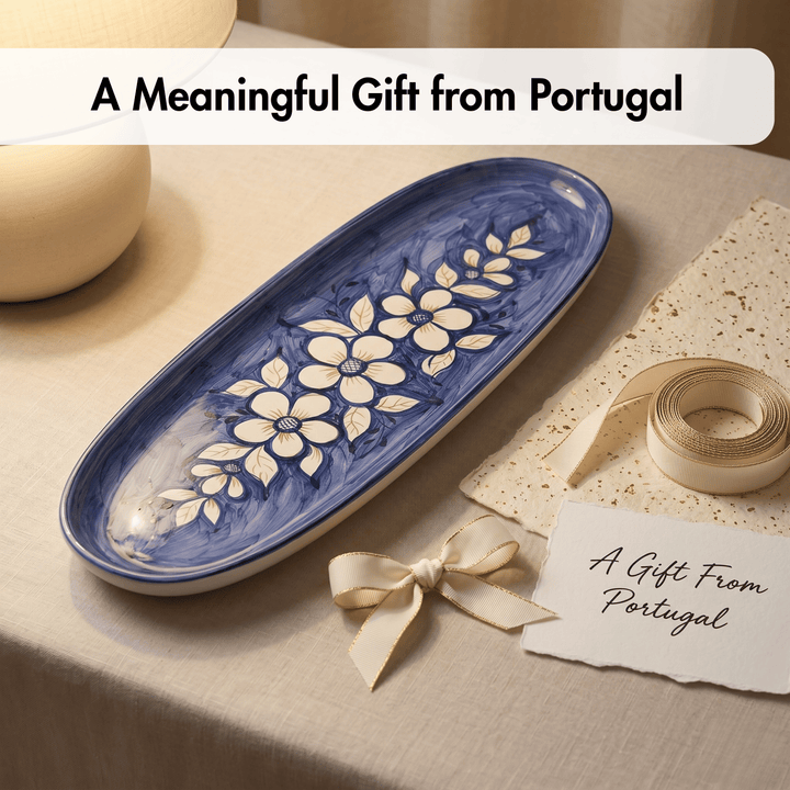 Ceramic tray with floral design on a table with a gift tag, ribbon, and text 'A Meaningful Gift from Portugal'.