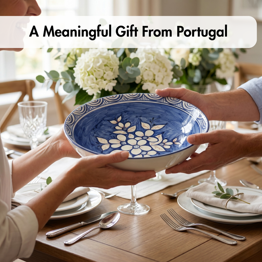 Two people holding a blue and white ceramic bowl with floral design on a dining table.