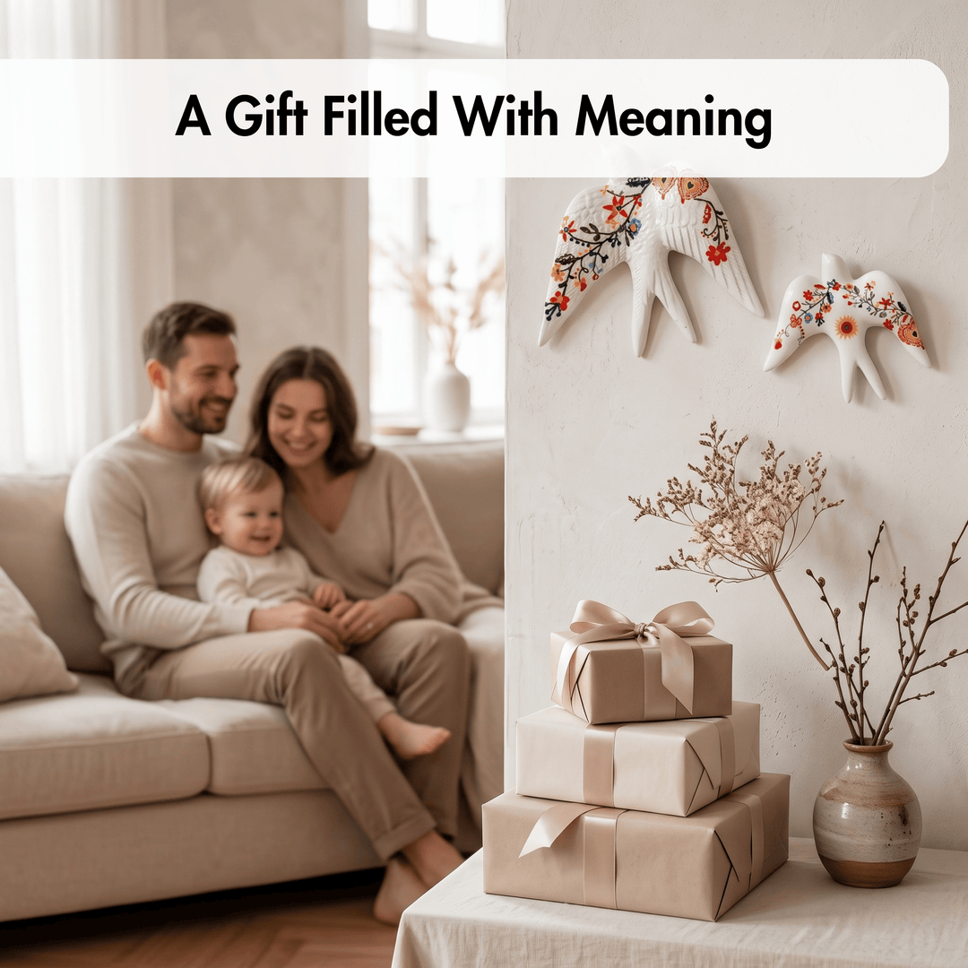 A warm lifestyle scene showing a family of three sitting together on a beige sofa, with wrapped gift boxes stacked on a table in the foreground and decorative wall hangings and dried branches in a vase. Text at the top reads, &