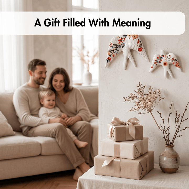 A warm lifestyle scene showing a family of three sitting together on a beige sofa, with wrapped gift boxes stacked on a table in the foreground and decorative wall hangings and dried branches in a vase. Text at the top reads, &