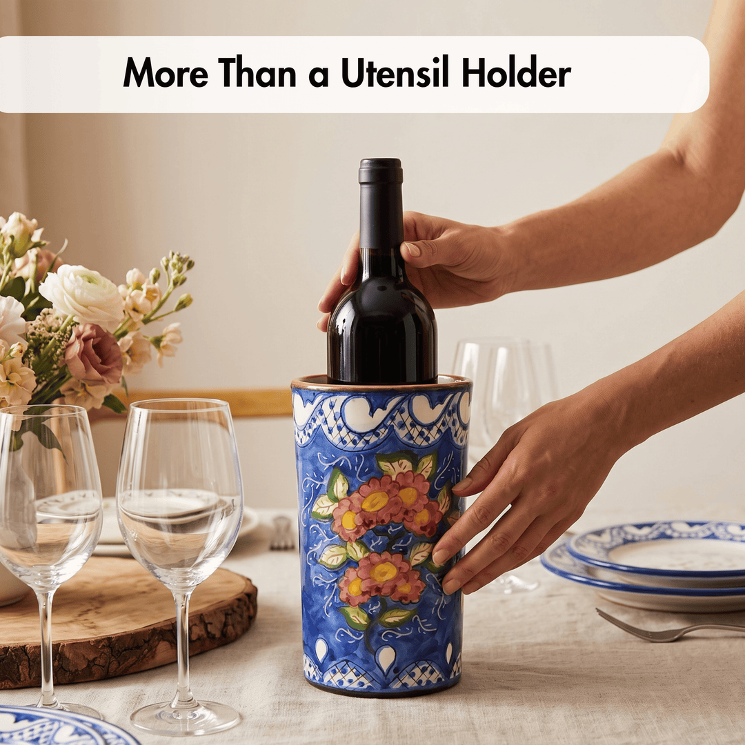 A ceramic wine bottle cooler with a blue floral pattern, shown on a dining table with a person&