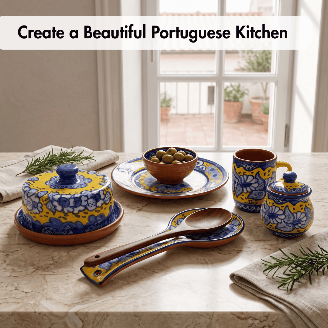 A set of colorful Portuguese-style ceramic tableware displayed on a stone countertop in a kitchen setting, including a lidded butter dish, plate with olives, mug, small lidded jar, spoons, and napkins, with text reading &