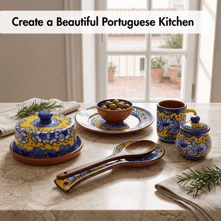 A set of colorful Portuguese-style ceramic tableware displayed on a stone countertop in a kitchen setting, including a lidded butter dish, plate with olives, mug, small lidded jar, spoons, and napkins, with text reading &