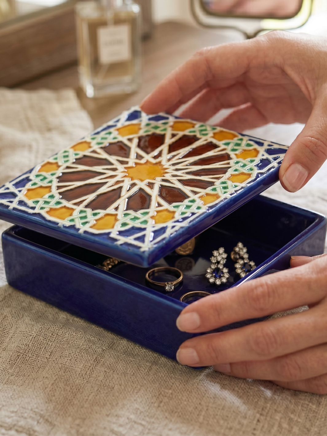 Decorative jewelry box with colorful mosaic design being opened by a hand.