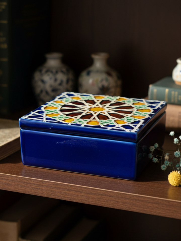 Decorative blue box with geometric pattern on a wooden surface