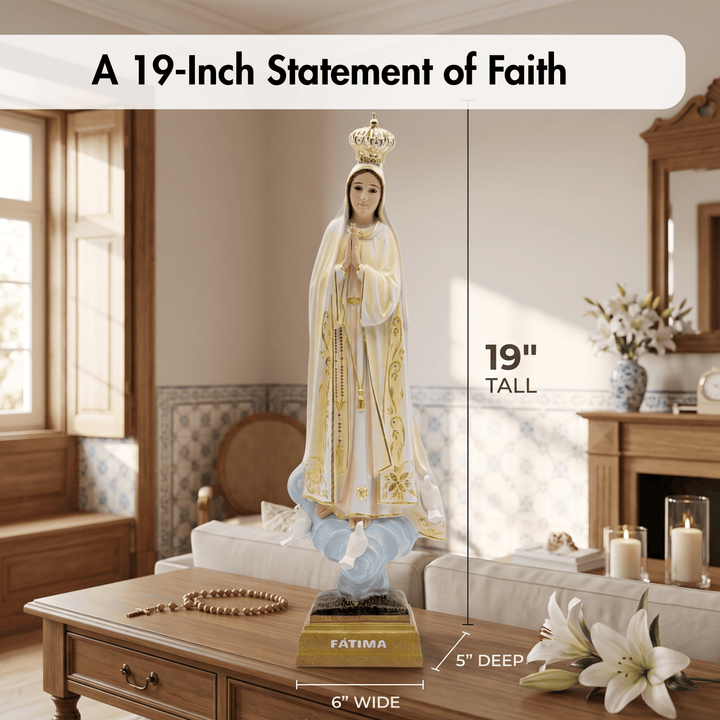 A 19-inch statement of faith statue of the Virgin Mary with a gold crown, white and gold robe, and blue cloak, displayed on a wooden table in a living room with dimension overlays showing its height, width, and depth.